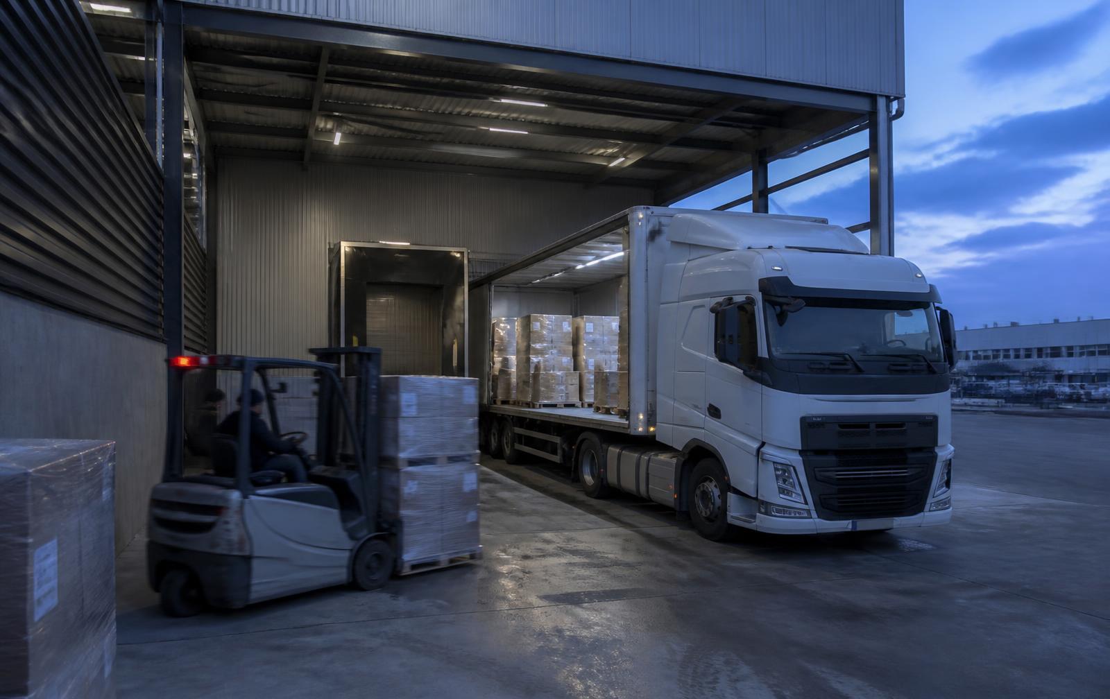 Pallets of IT equipment being loaded at an industrial dock